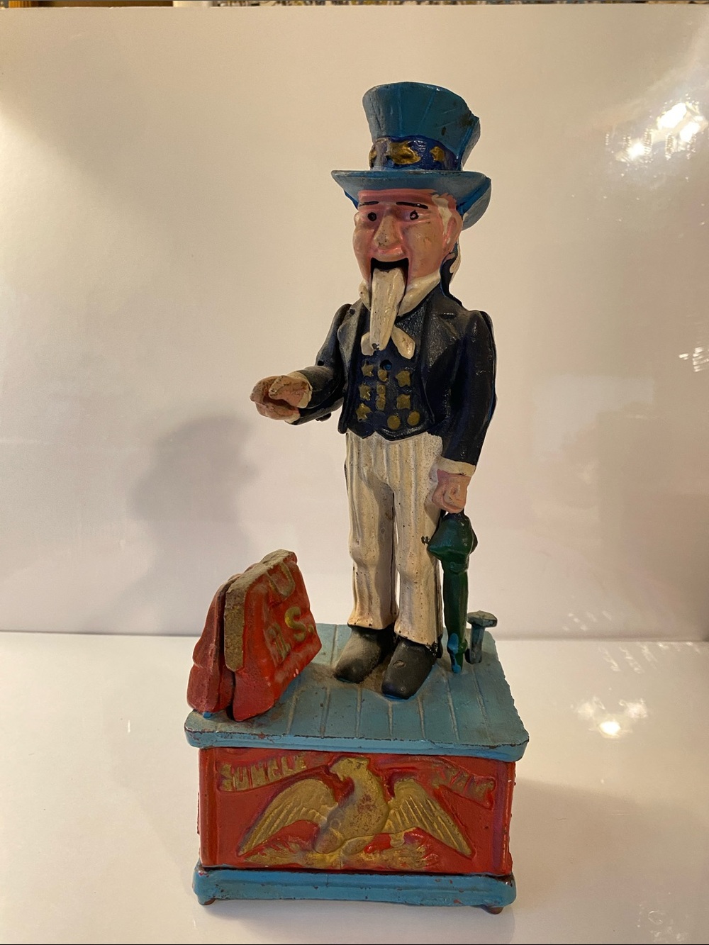 Patriotic Cast-Iron Uncle Sam Figurine Bank in Blue, Red, and Cream